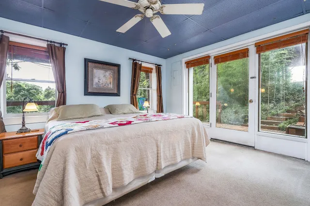 a bed sitting in a spacious bedroom next to a window