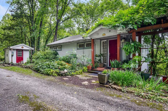 a front view of house with yard and green space