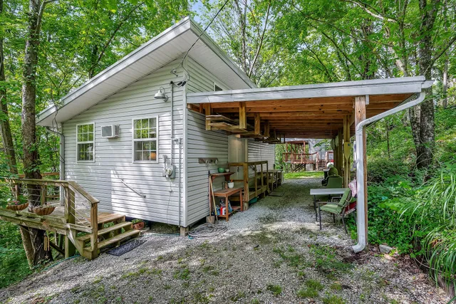 a view of a chair and table in backyard