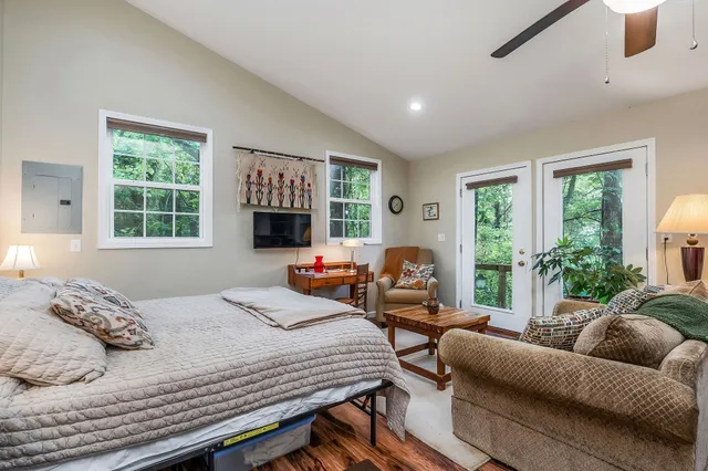 a bedroom with furniture and a flat screen tv