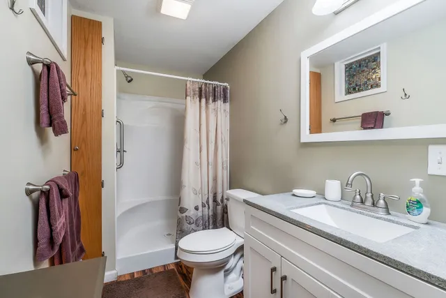 a bathroom with a sink toilet and shower