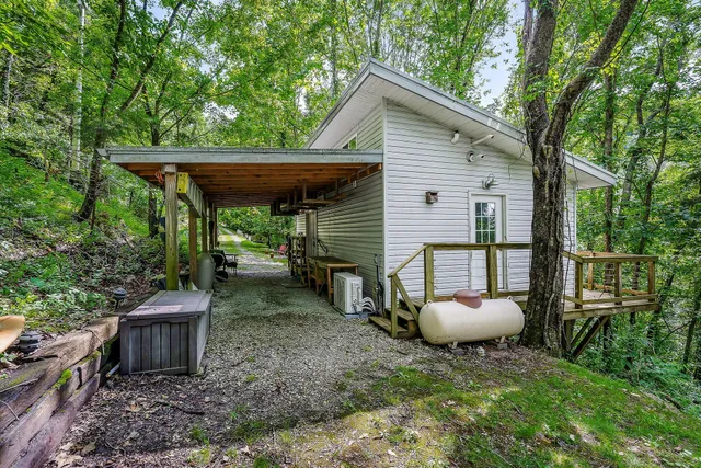 a backyard of a house with table and chairs