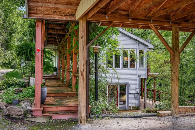 a view of a house with a tree front of house