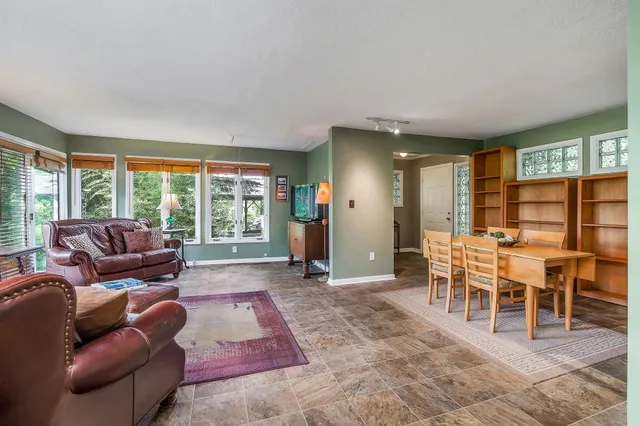 a living room with furniture and a floor to ceiling window