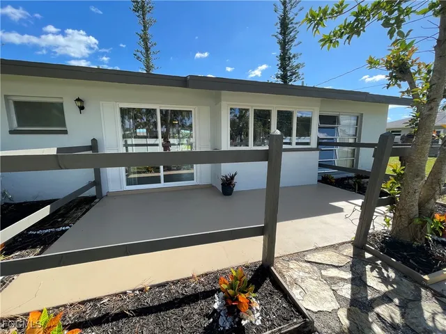 a view of a balcony with furniture and a potted plant