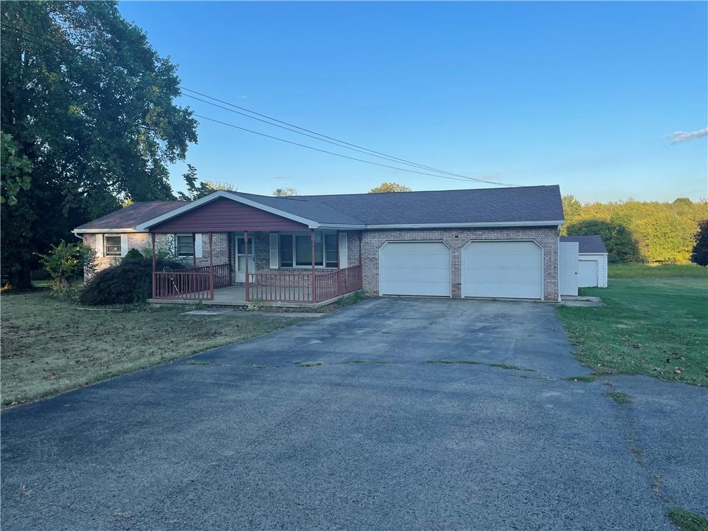 33 Hogue Road West Middlesex, PA 16159 - Photo 1 of 29 a front view of a house with a yard and garage