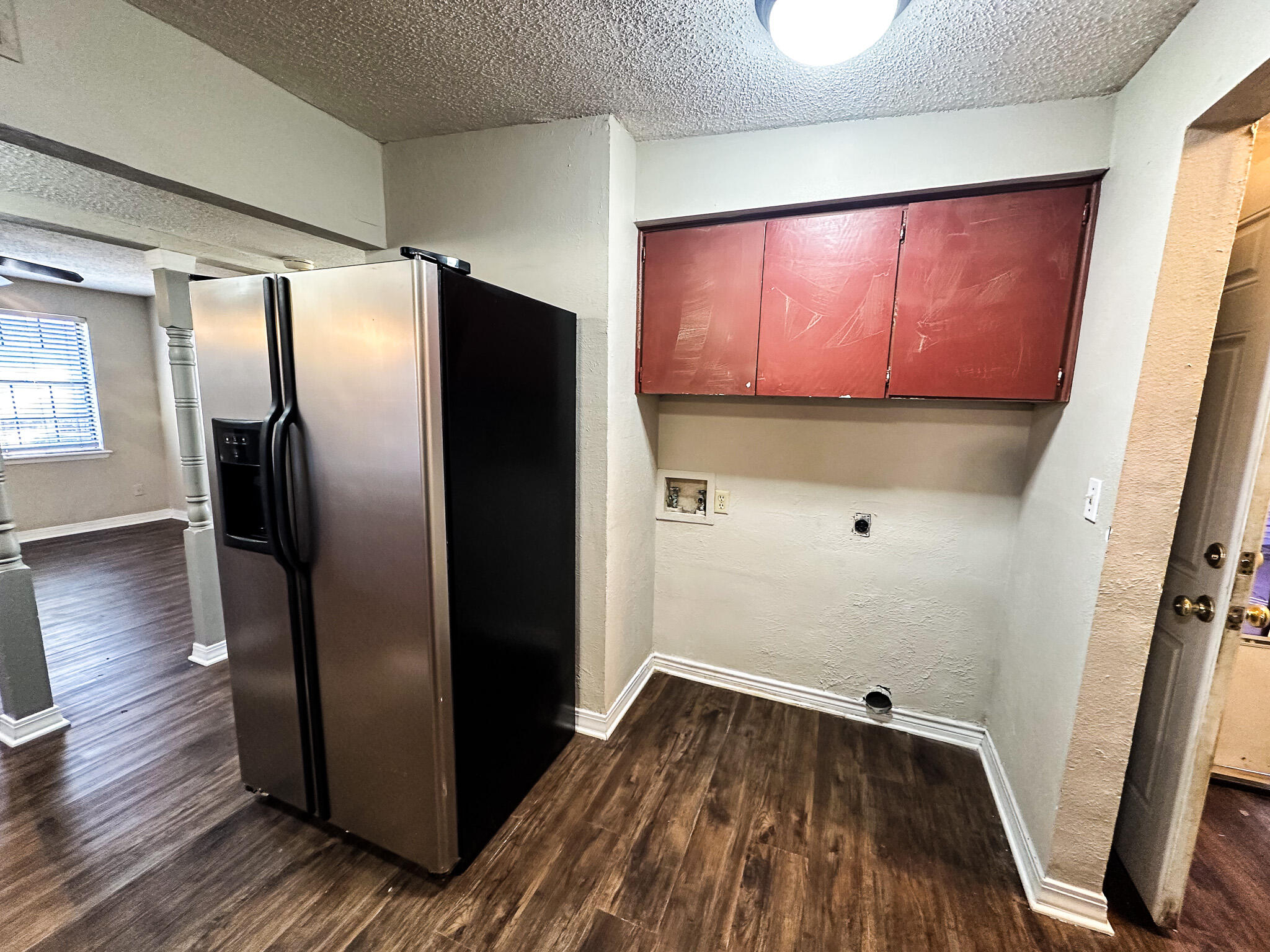 2101 48th Street Lubbock, TX 79412 - Photo 12 of 36 a view of a refrigerator in kitchen and wooden floor