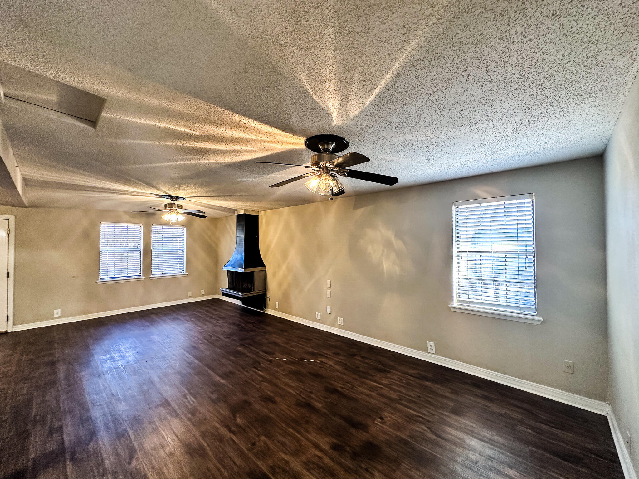2101 48th Street Lubbock, TX 79412 - Photo 29 of 36 a view of an empty room with wooden floor and a window