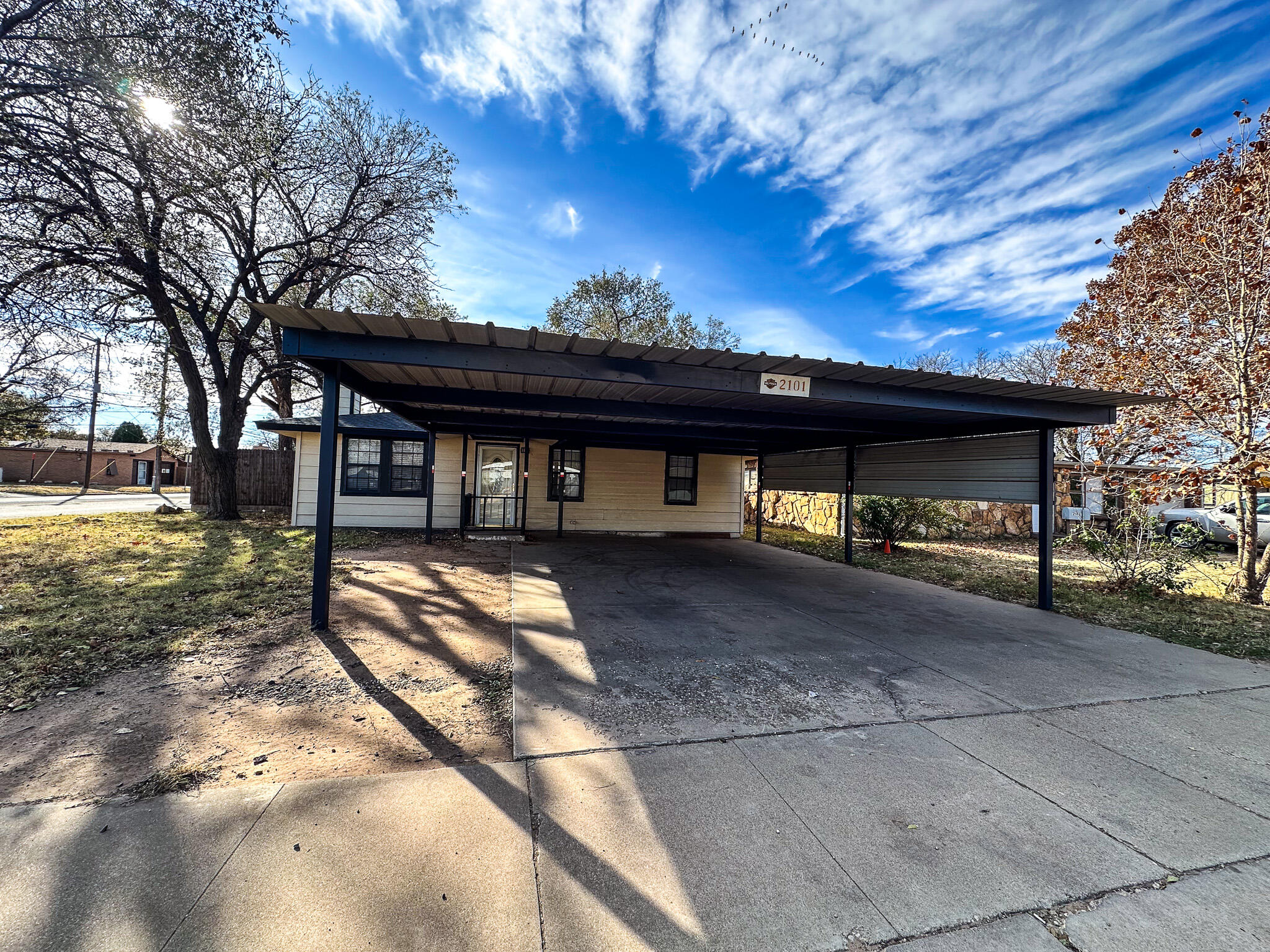 2101 48th Street Lubbock, TX 79412 - Photo 3 of 36 a view of a house with a yard and large tree