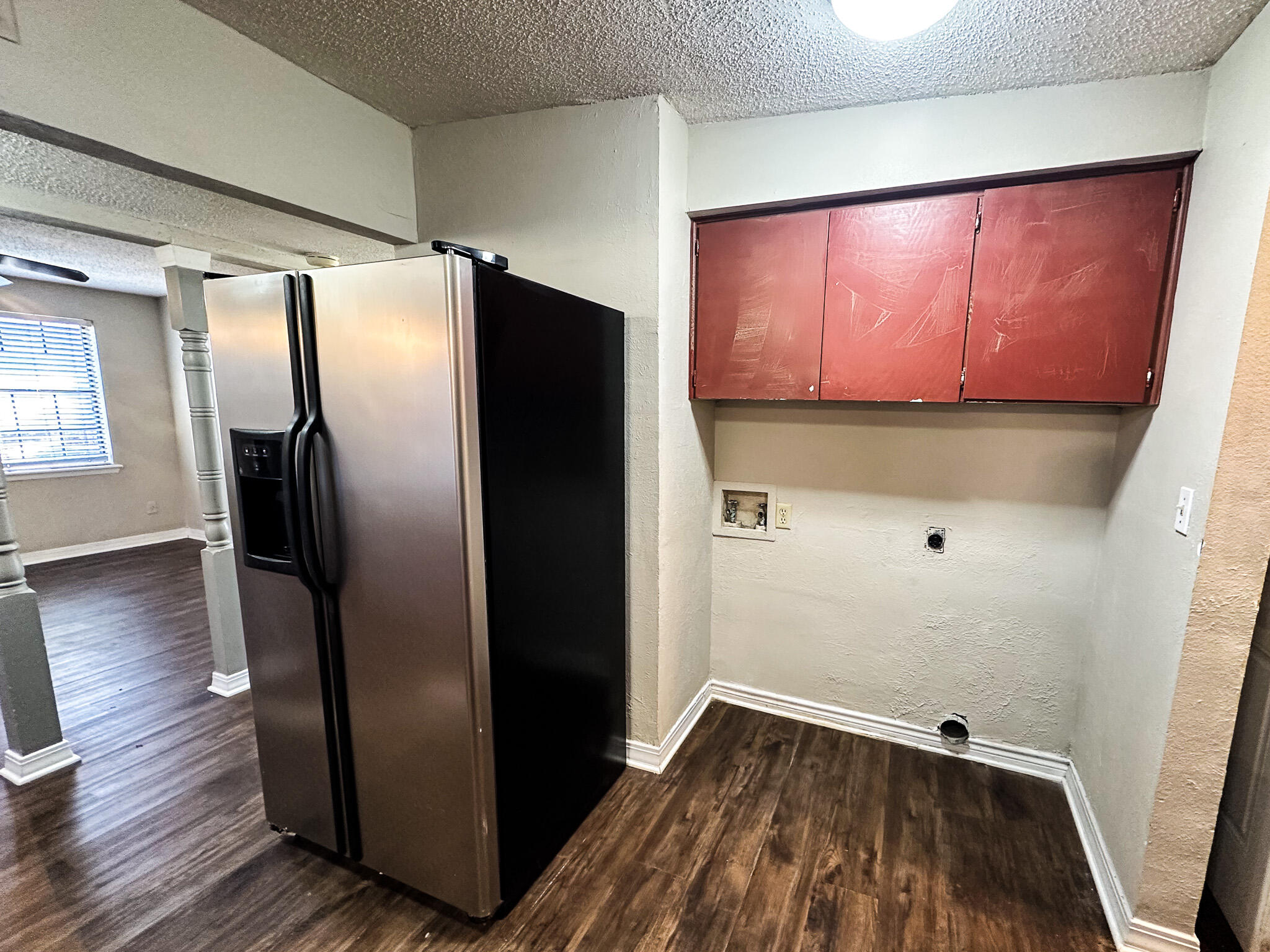 2101 48th Street Lubbock, TX 79412 - Photo 31 of 36 a view of a refrigerator in kitchen and wooden floor