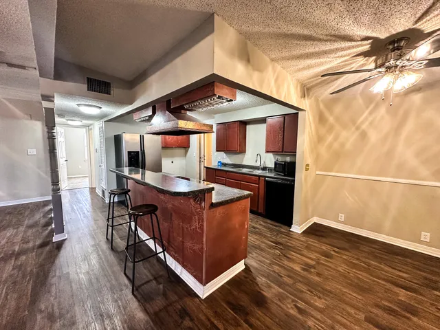 a kitchen with stainless steel appliances granite countertop a stove and a refrigerator