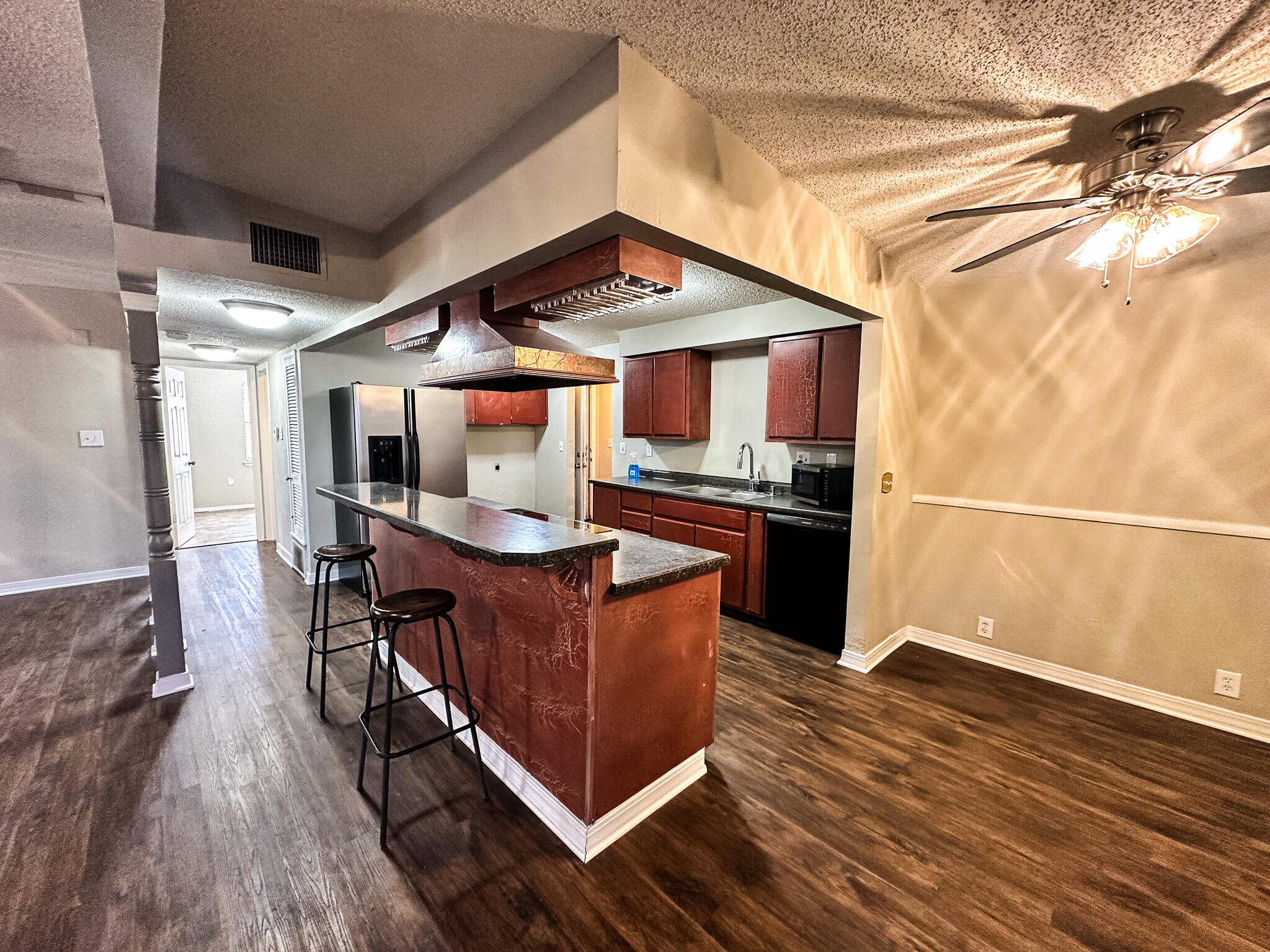 2101 48th Street Lubbock, TX 79412 - Photo 8 of 36 a kitchen with stainless steel appliances granite countertop a stove and a refrigerator