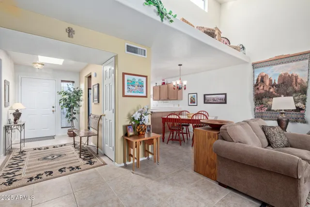a living room with furniture a rug and white walls