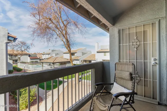 a view of a chairs and table in the balcony