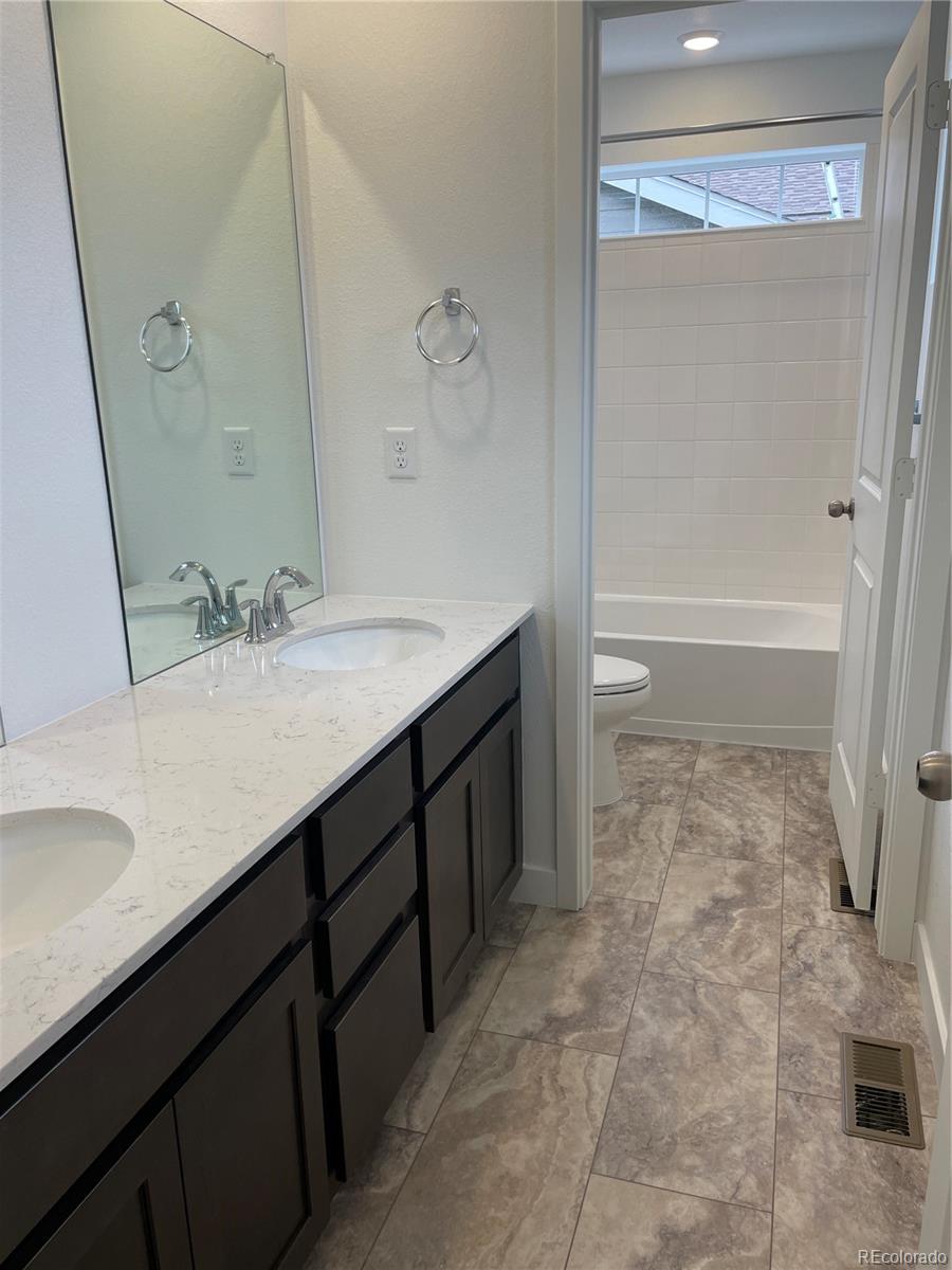 12880 Range Street Firestone, CO 80504 - Photo 11 of 21 a bathroom with a sink a toilet and shower