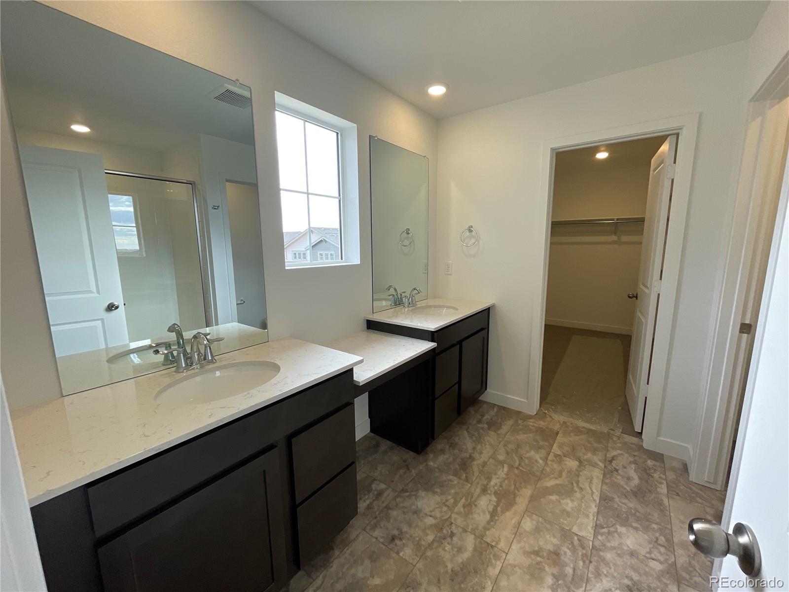 12880 Range Street Firestone, CO 80504 - Photo 6 of 21 a bathroom with a sink double vanity granite tub shower and a mirror