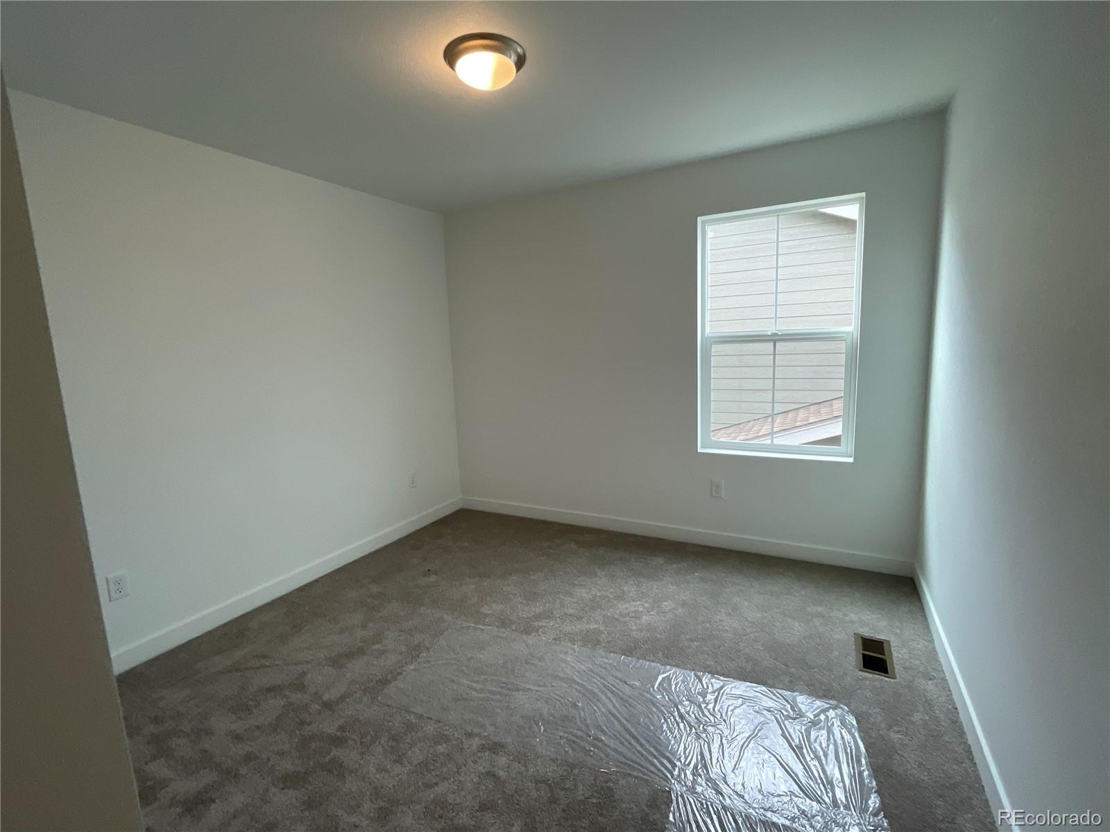 12880 Range Street Firestone, CO 80504 - Photo 7 of 21 an empty room with a window