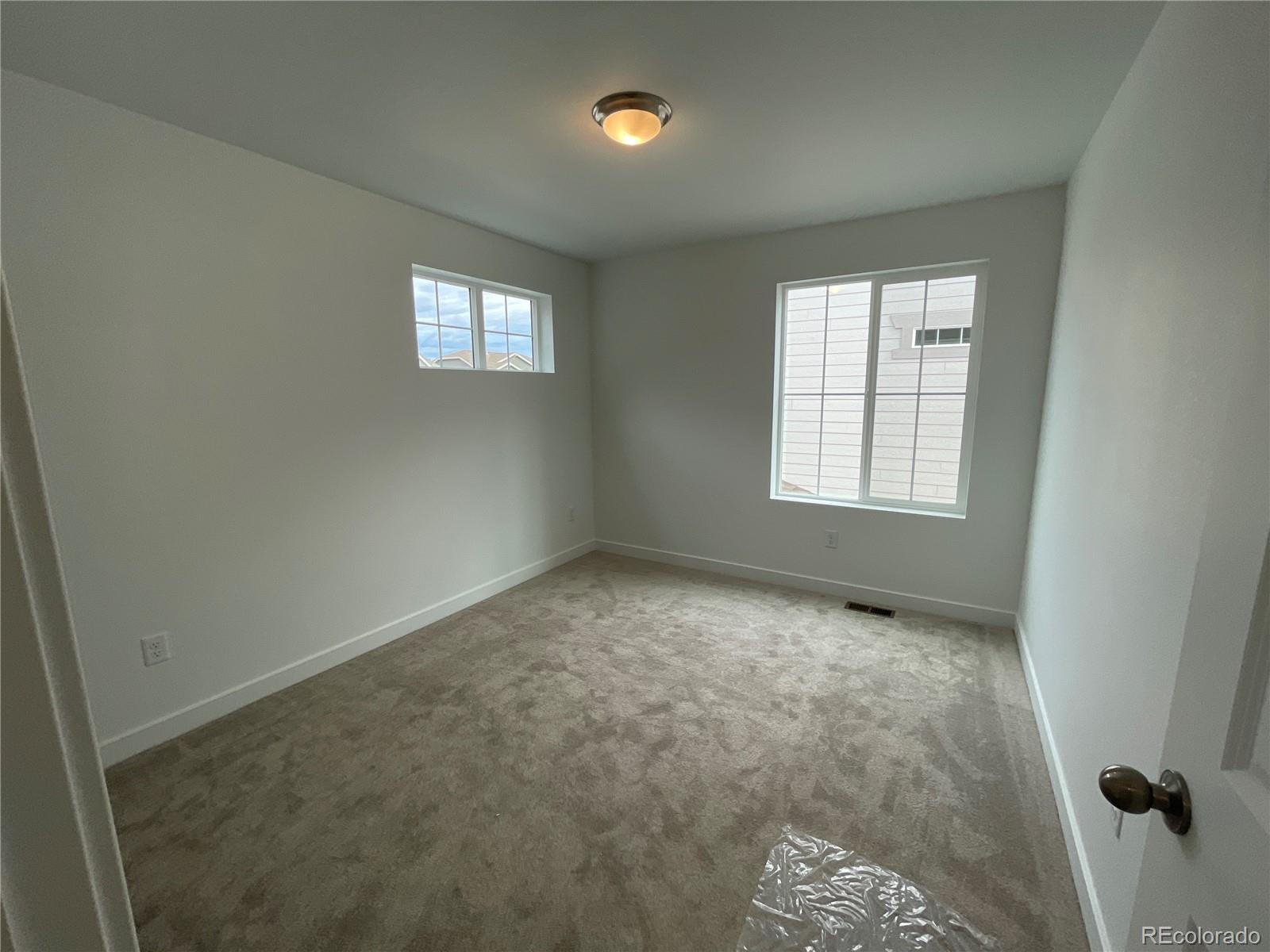 12880 Range Street Firestone, CO 80504 - Photo 8 of 21 an empty room with windows