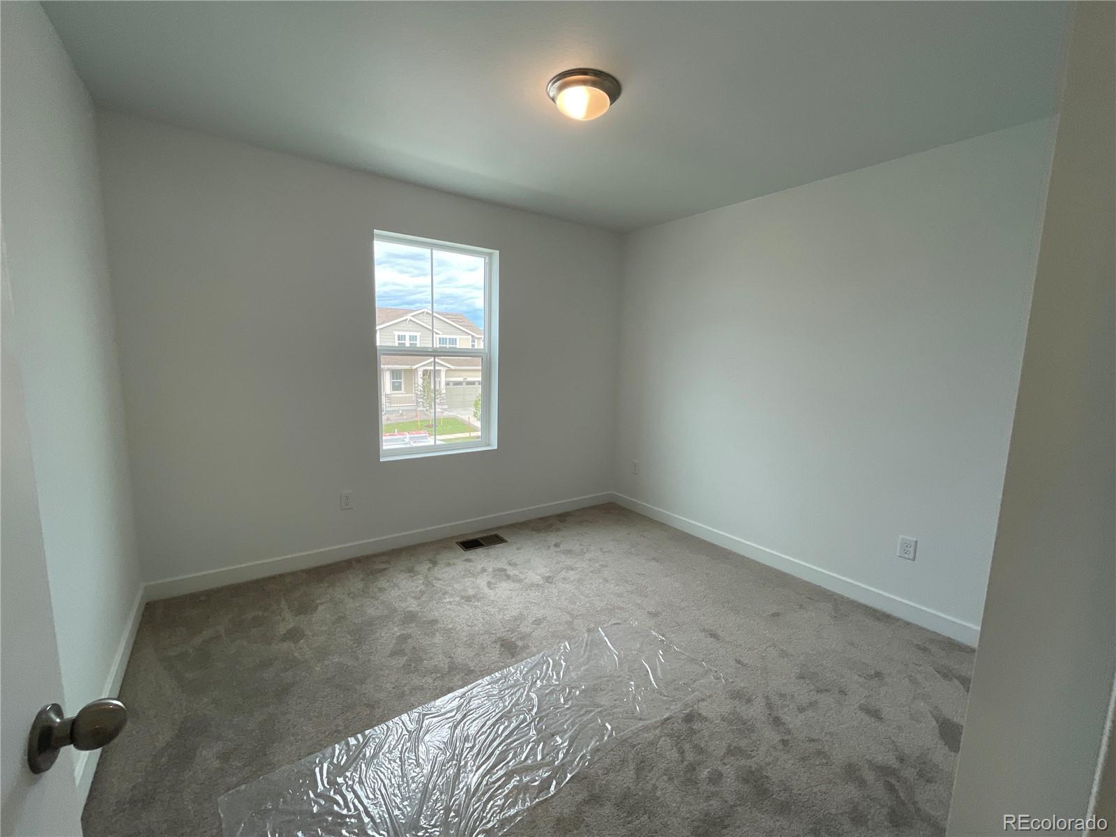 12880 Range Street Firestone, CO 80504 - Photo 9 of 21 an empty room with a window