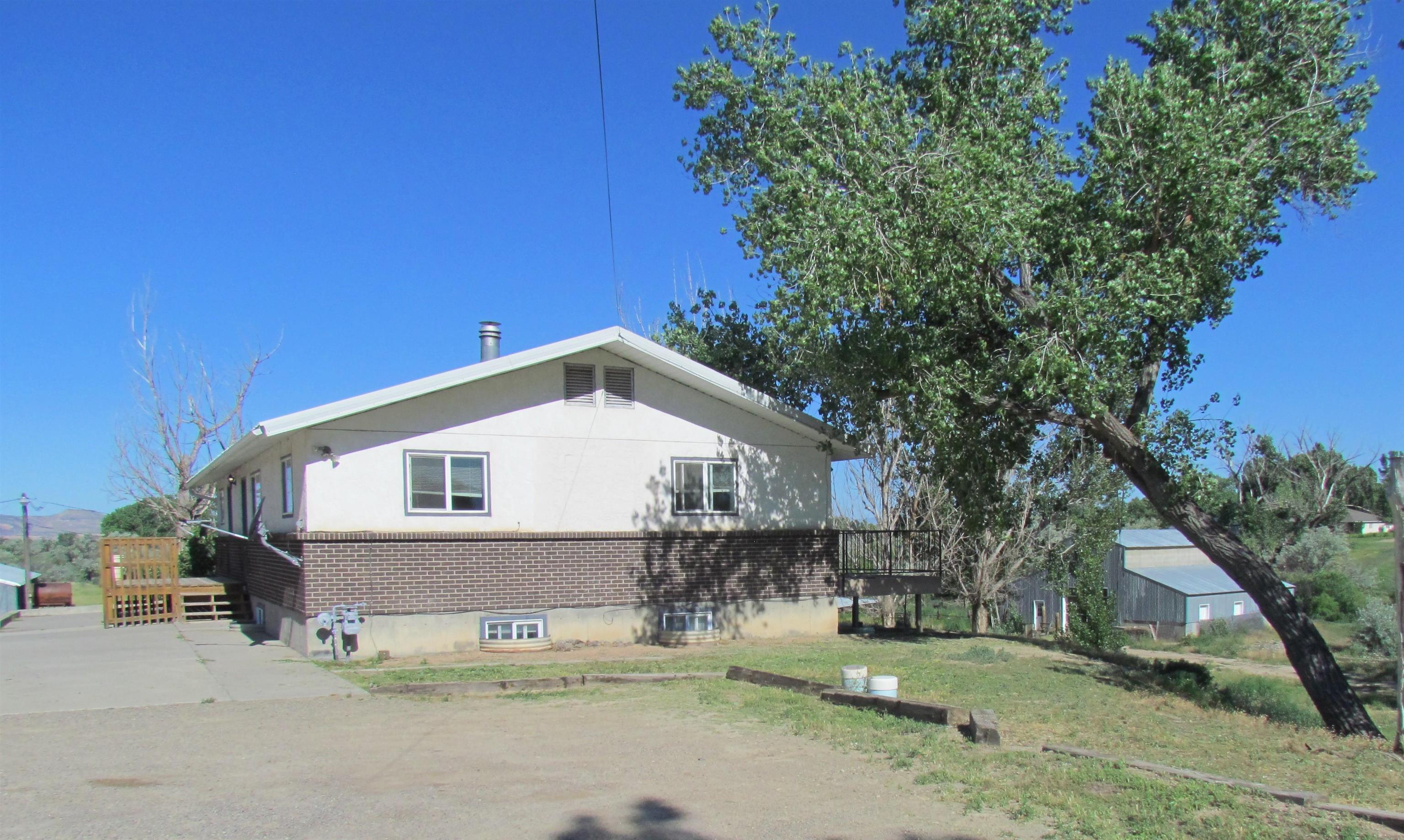 1179 17 Road Fruita, CO 81521 - Photo 5 of 41 a front view of a house with a yard