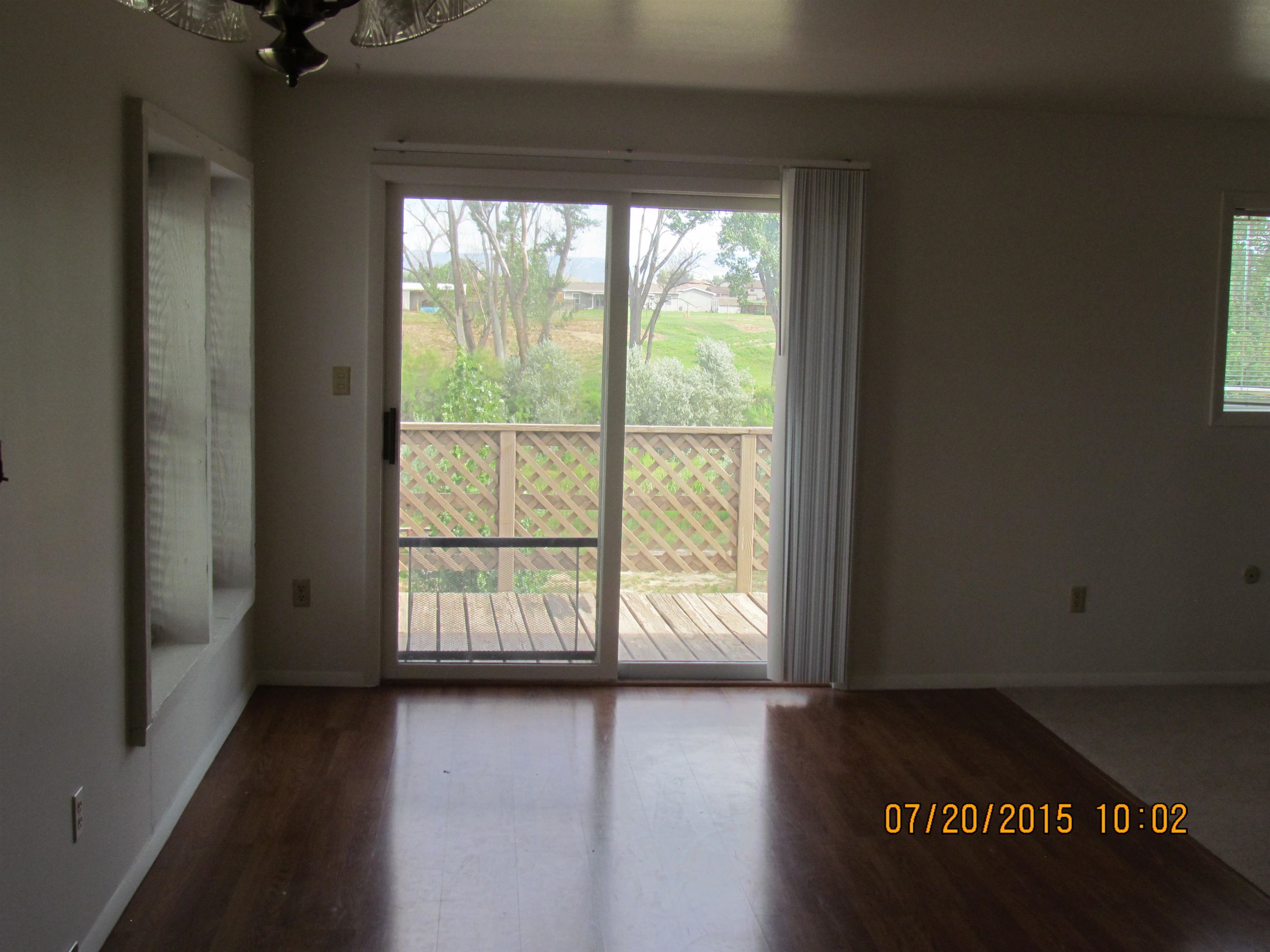 1179 17 Road Fruita, CO 81521 - Photo 9 of 41 an empty room with wooden floor and windows