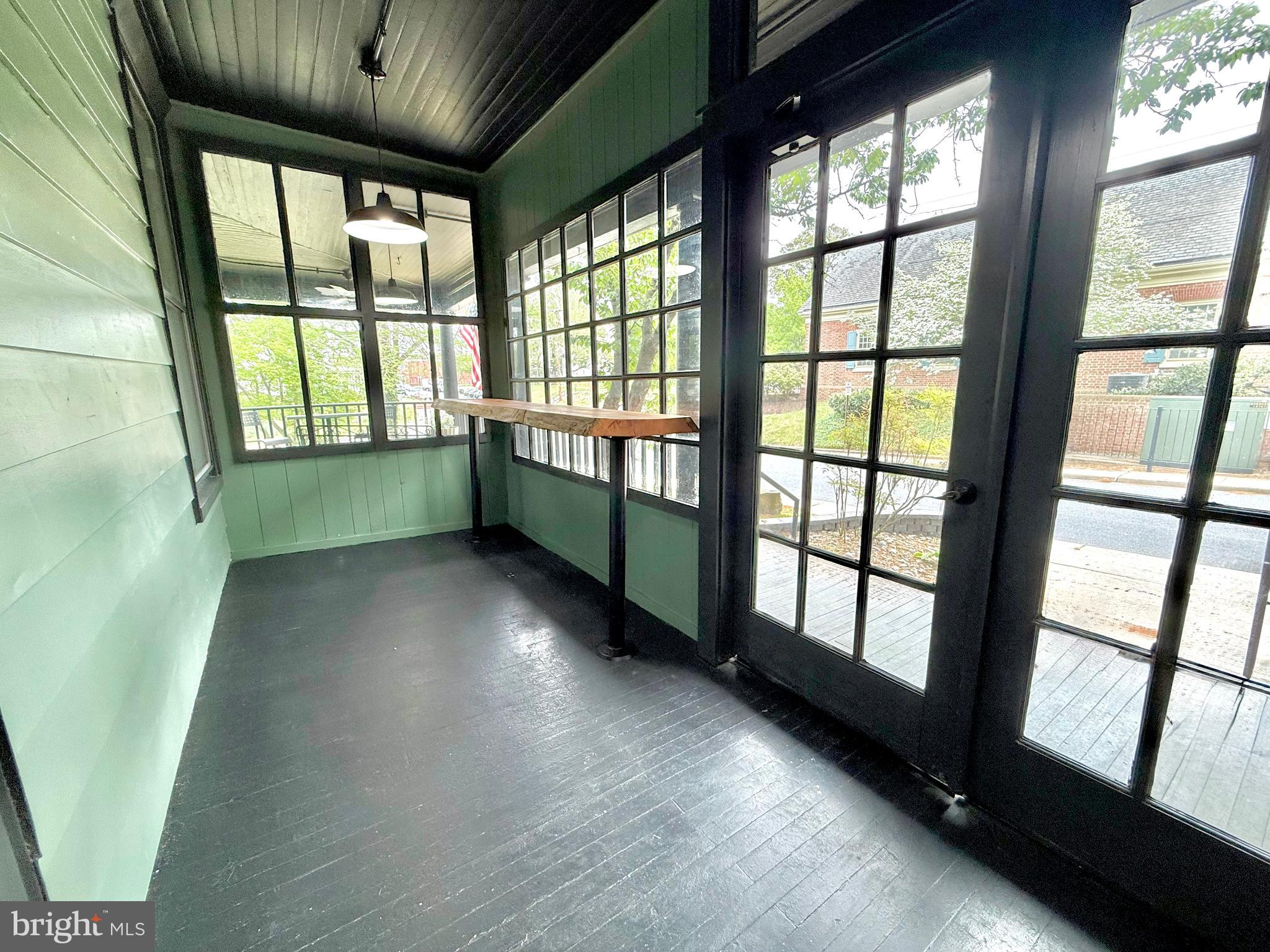 4 South 1st Street Denton, MD 21629 - Photo 74 of 112 a view of an empty room with wooden floor and a window