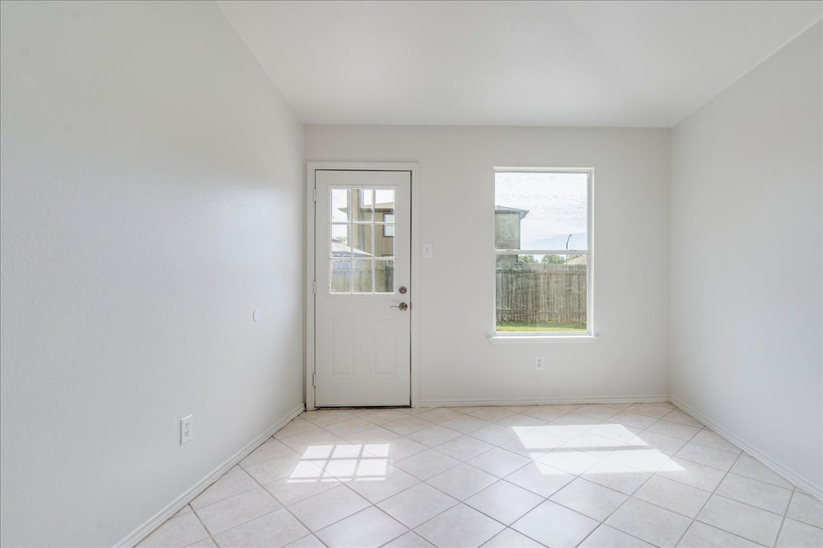 100 Easy Street Hutto, TX 78634 - Photo 12 of 36 A well-lit, adaptable room features easy-care tile flooring and a view of the outdoors.