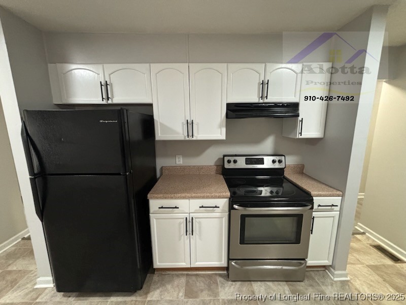 1810 Murchison Road Fayetteville, NC 28301 - Photo 5 of 10 a kitchen with a stove and a refrigerator