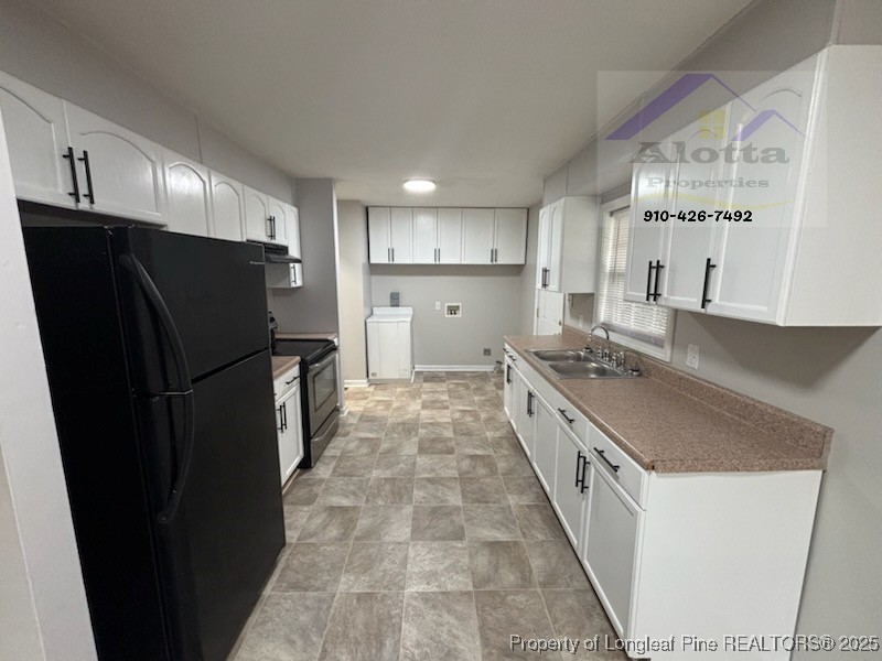 1810 Murchison Road Fayetteville, NC 28301 - Photo 6 of 10 a large kitchen with a stove a refrigerator and a sink