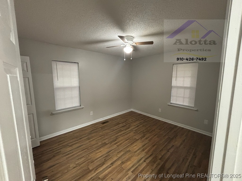 1810 Murchison Road Fayetteville, NC 28301 - Photo 9 of 10 an empty room with wooden floor closet and windows