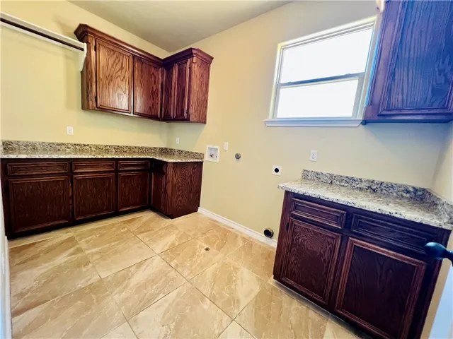 a kitchen with stainless steel appliances granite countertop wooden cabinets a stove top oven a sink and dishwasher