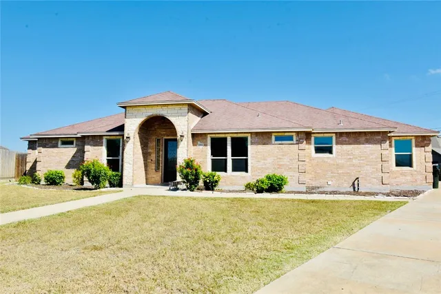 a front view of a house with yard and garage