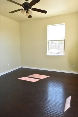 a view of a room with wooden floor and fan