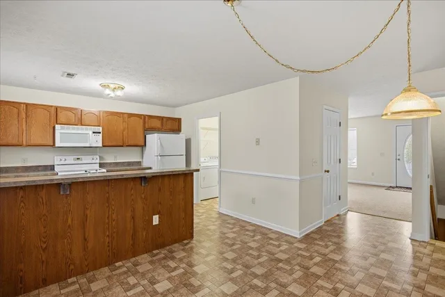 a view of a kitchen with stainless steel appliances a refrigerator and a sink