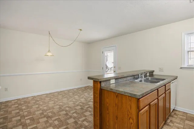 a bathroom with a granite countertop sink a toilet and mirror