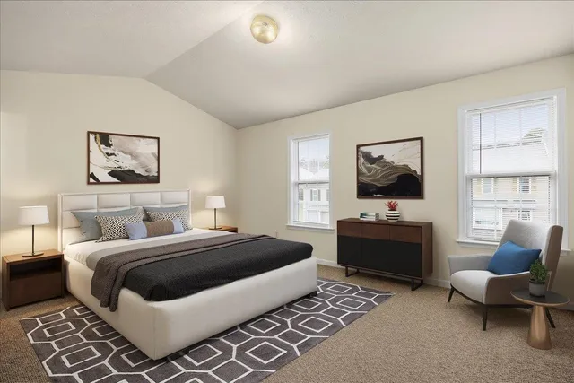 a bedroom with a large bed and a flat screen tv