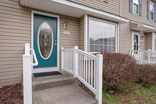 a view of a house with a small yard and wooden fence