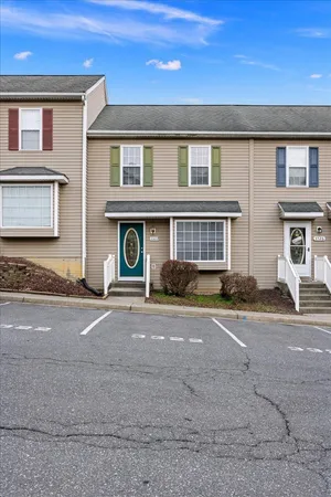 a front view of a house with a road
