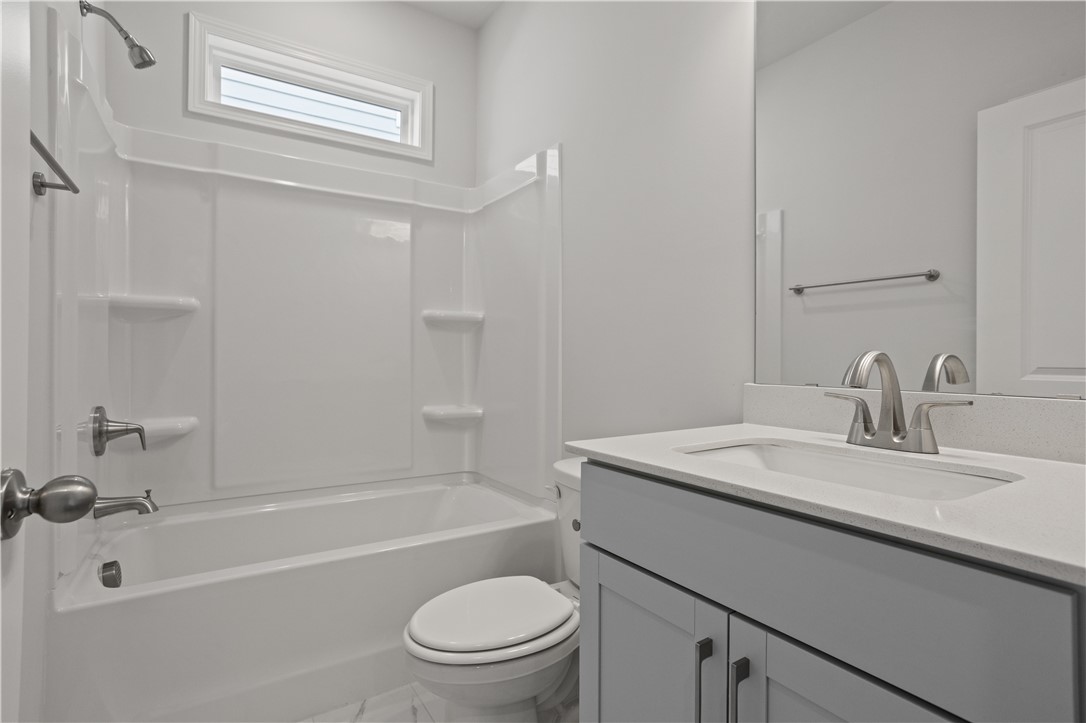 555 Hydrangea Street, Unit LOT 47 Seneca, SC 29678 - Photo 19 of 38 A pristine bathroom features a single vanity and a combination shower-tub unit, offering both functionality and comfort.