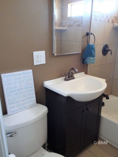 437 North Fairview Street Ridgecrest, CA 93555 - Photo 24 of 35 a bathroom with a sink a toilet and mirror