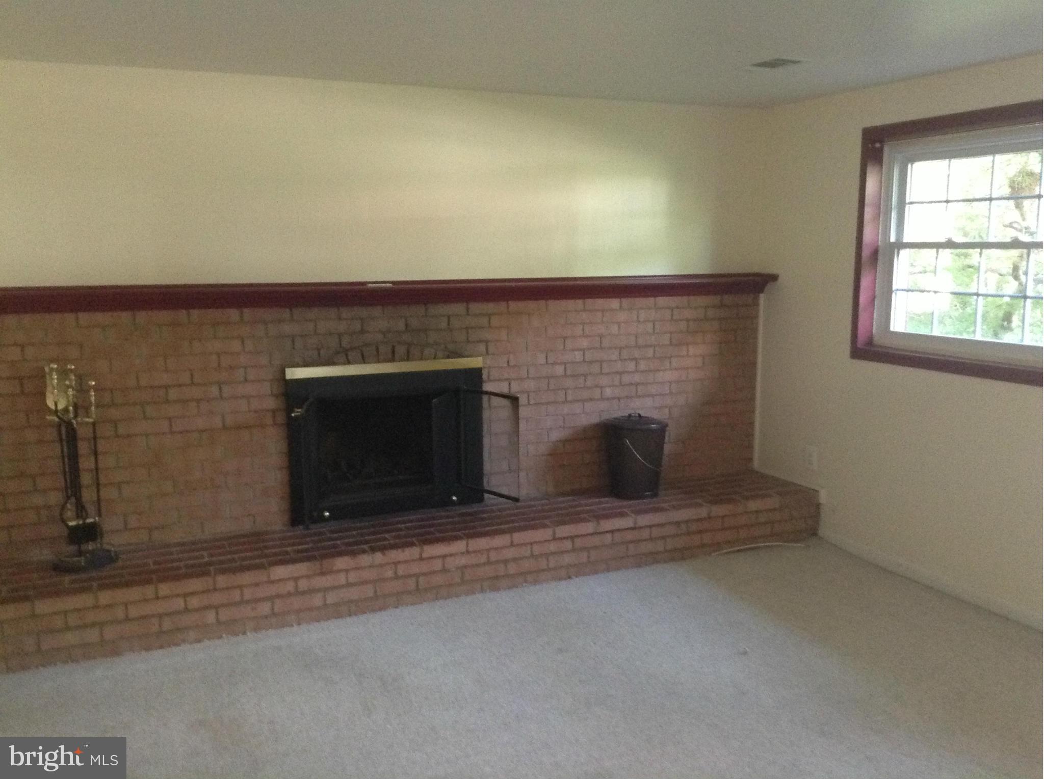 16308 Dahl Road Laurel, MD 20707 - Photo 8 of 9 an empty room with a fireplace
