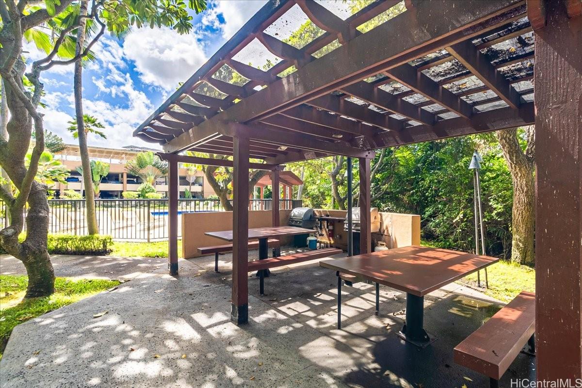 5333 Likini Street, Unit 1110 Honolulu, HI 96818 - Photo 24 of 25 a view of a patio with a table chairs and a backyard