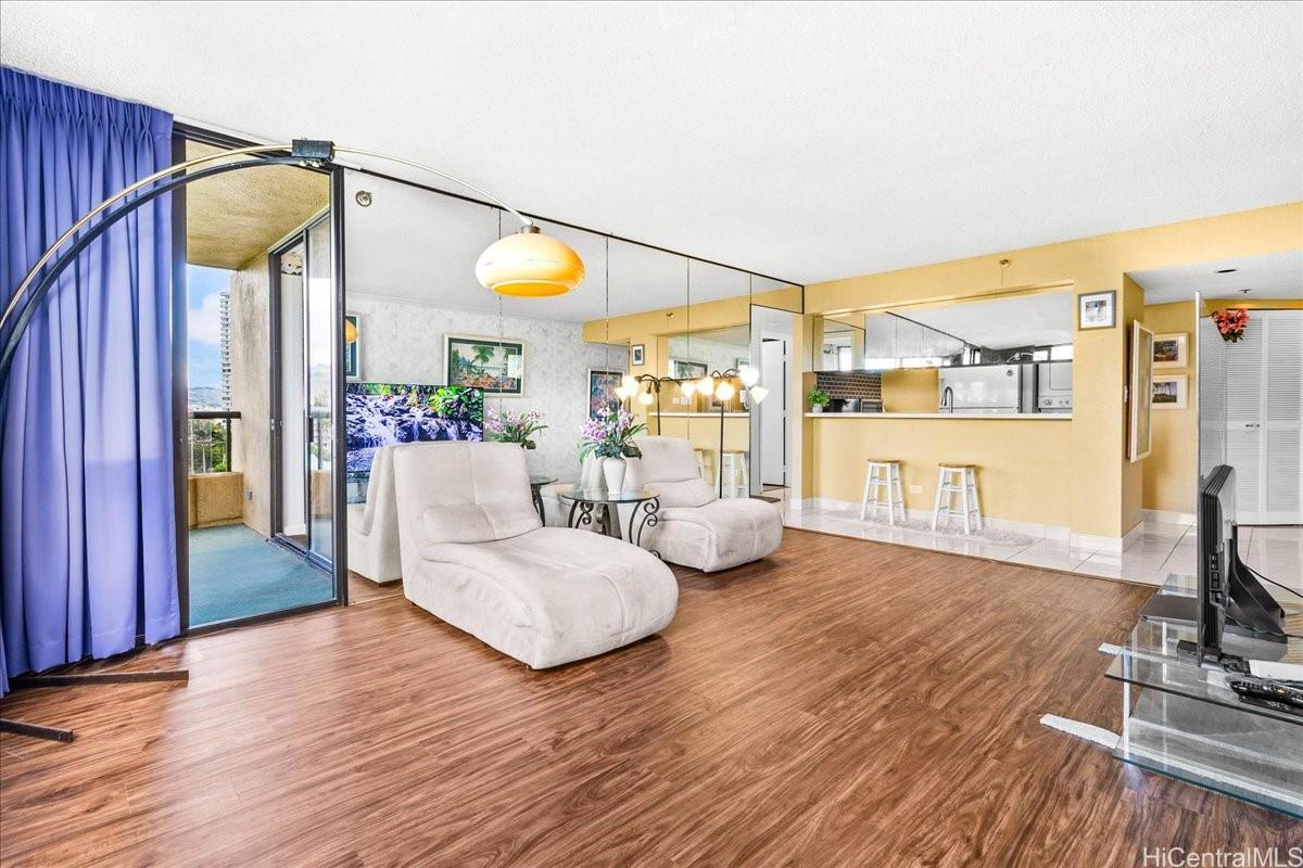 5333 Likini Street, Unit 1110 Honolulu, HI 96818 - Photo 7 of 25 a living room with furniture and a wooden floor