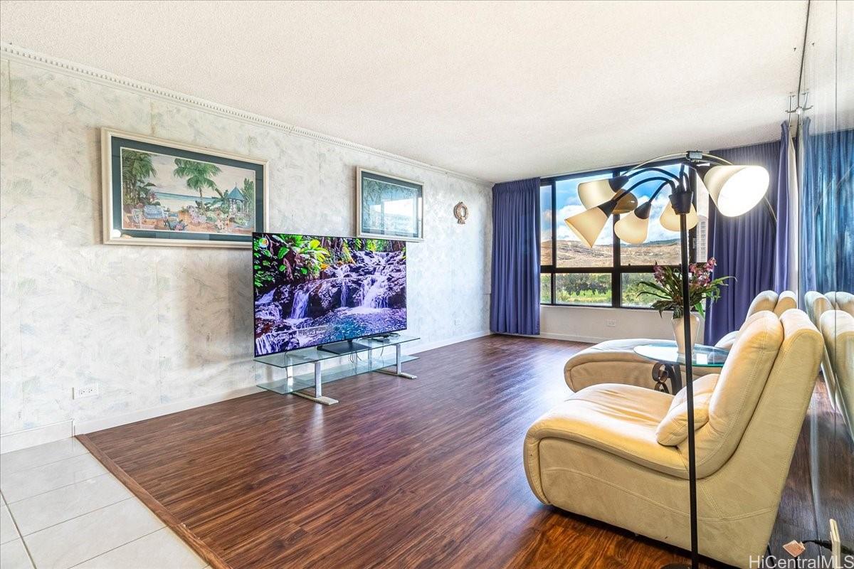 5333 Likini Street, Unit 1110 Honolulu, HI 96818 - Photo 8 of 25 a living room with furniture and a wooden floor