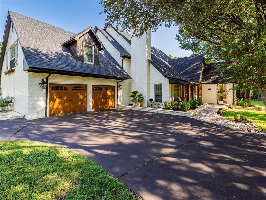 153 Meadowcreek Road Coppell, TX 75019 - Photo 1 of 35 a front view of a house with garden