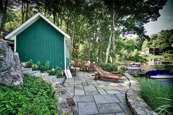 a view of a chair and tables in the backyard of the house