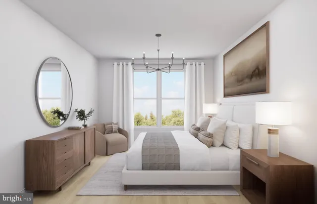 a bedroom with a bed a mirror on dresser and a window