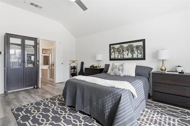 a bed room with a bed and a painting on the wall