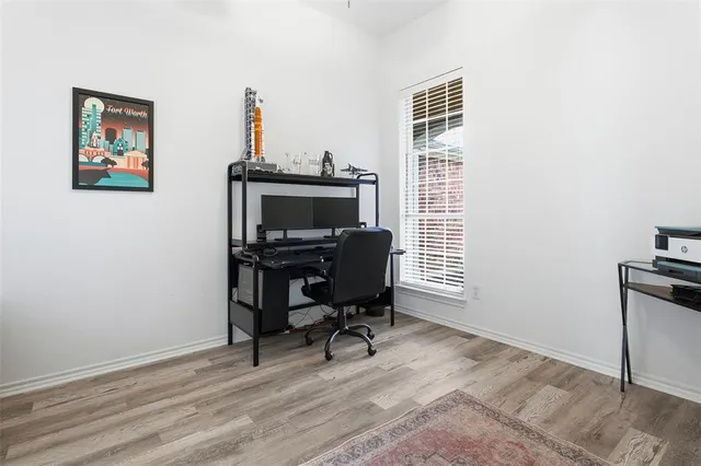 a view of a workspace with furniture and a window