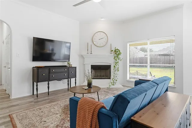a living room with furniture a fireplace and a flat screen tv